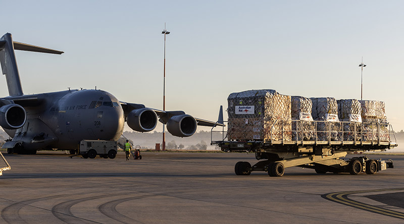 Pallets of aid from Australia and the United Kingdom bound for Enga Province in Papua New Guinea wait to be loaded onto a C-17A Globemaster III at RAAF Base Amberley. Photo by Corporal Brett Sherriff.