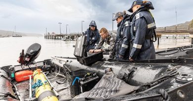 Royal Australian Navy Able Seaman Shannae Fiddyment, Petty Officer Eric Duthie, Able Seaman Grace Fox and Able Seaman Henrietta Bradford prepare communication equipment for a Remus 100S autonomous underwater vehicle during Exercise AUKUS at Pittwater, New South Wales. Photo by Able Seaman Lucinda Allanson.