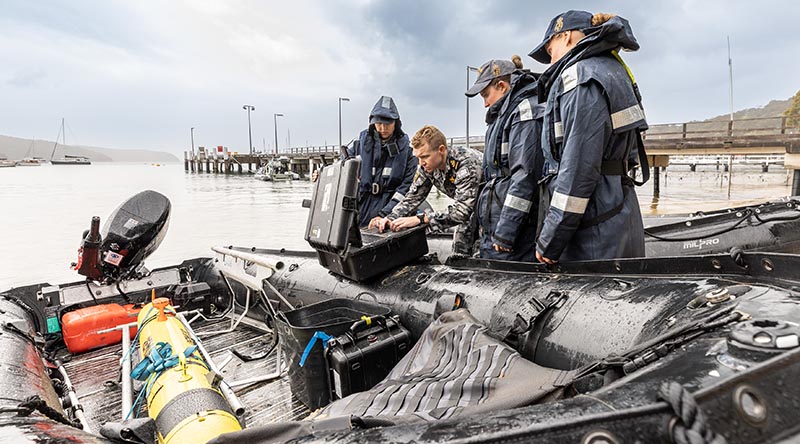 Royal Australian Navy Able Seaman Shannae Fiddyment, Petty Officer Eric Duthie, Able Seaman Grace Fox and Able Seaman Henrietta Bradford prepare communication equipment for a Remus 100S autonomous underwater vehicle during Exercise AUKUS at Pittwater, New South Wales. Photo by Able Seaman Lucinda Allanson.