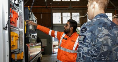 Saurabh Sibal, assistant project officer for NSW SES, shows Flying Officer Phillip Davies equipment loaded onto an SES vehicle during Exercise Cannonball at RAAF Base Richmond. Story by Flying Officer Madeleine Magee. Photos by Sergeant Dan Pinhorn.