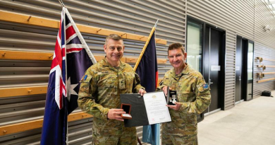 Major Stephen Ware, right, is presented with two Federation Stars by Major General Gregory Novak at Gallipoli barracks, Brisbane. Story by Captain Cody Tsaousis. Photo by Private Alfred Stauder.