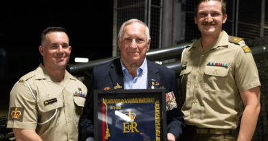 Ken Murphy stands with Battery Commander Major Jack Bagwill, right, and Battery Sergeant Major, Warrant Officer Class Two Chris Saetta, following the presentation of the Queen's Banner at Robertson Barracks. Story by Captain Annie Richardson.