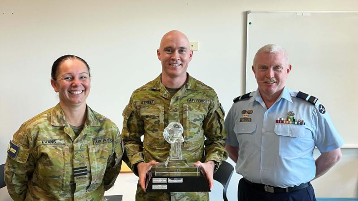 Leading Aircraftman Paul Street, centre, receives the CSG Aviator of the Year and bronze commendation for his work designing and building the frame for the Health OCU BlueRoom simulator. Story by Corporal Jacob Joseph.