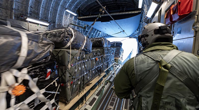 No. 36 Squadron Loadmaster Corporal Deon Jones watches as palletised cargo rolls off the ramp of a Royal Australian Air Force C-17A Globemaster III during an airdrop of supplies to Mawson Research Station, Antarctica. Photo by Petty Officer Bradley Darvill.