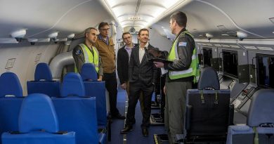 Squadron Leader Joshua Brown, right, describes the P-8A Poseidon airborne electronics analyst work stations to Squadron Leader Cosimo Panetta, left, and visiting contractors Peter Ryder, Adam Webber and Justin King. Story by Flying Officer Xavier Szegi. Photos by Leading Aircraftman Sam Price.