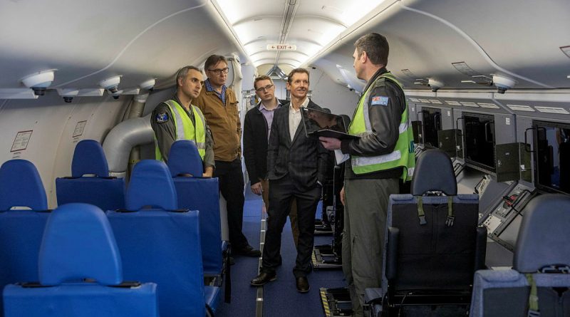 Squadron Leader Joshua Brown, right, describes the P-8A Poseidon airborne electronics analyst work stations to Squadron Leader Cosimo Panetta, left, and visiting contractors Peter Ryder, Adam Webber and Justin King. Story by Flying Officer Xavier Szegi. Photos by Leading Aircraftman Sam Price.