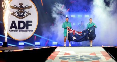 Team Australia captains Sergeant Emily Lahey, right, and Cooper Blackwood carry the Australian National Flag as they lead the Australian contingent competing at the Warrior Games 2024 on to the stage for the closing ceremony. Story by Flying Officer Belinda Barker. Photos by Flight Sergeant Christopher Dickson.