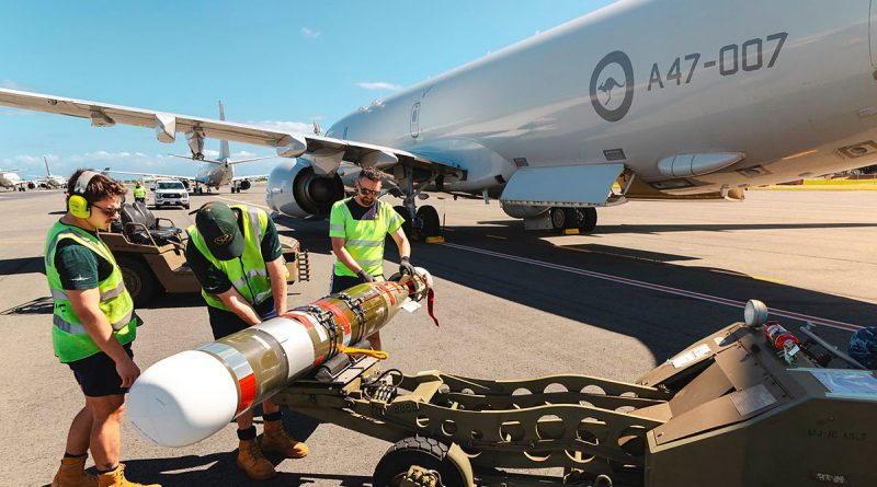 Air Force aviators from 11 Squadron transfer a Mk54 Lightweight exercise torpedo to a RAAF P-8A Poseidon during Exercise Rim of the Pacific 2024, at Joint Base Pearl Harbor-Hickam, Hawaii. Story by Lieutenant Carolyn Martin. Photos by Corporal Adam Abela.
