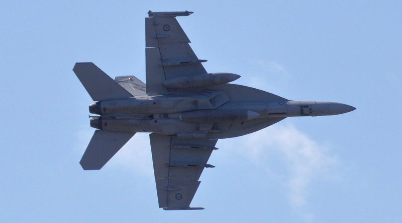 A F/A-18F Super Hornet from 1 Squadron conducts a low-level flypast over Cairns Esplanade, enthralling the local community during Exercise Crimson Dawn. Story by Flight Lieutenant Imogen Lunny. Photo by Jonathan Williams.