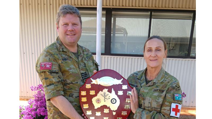 Sergeant Deborah Williamson, right, receives the McCarthy Rowbottom Jones Memorial Award by Group Captain John Rollo. Story by Corporal Melina Young.