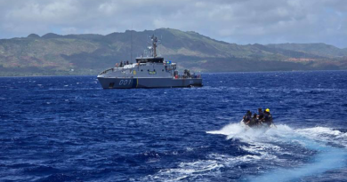 A Republic of the Marshall Islands team from the Pacific Forum-class RMIS Lomor approaches the Guardian-class patrol ships PSS President HI Remeliik II from the Republic of Palau to run through a mock law enforcement boarding off Guam. Story by Leon Ha. Photo by Chief Petty Officer Aaron Wheeler.
