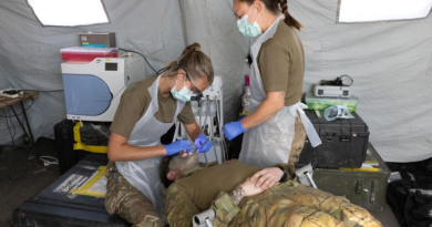 Royal Navy's dental surgeon Lieutenant Grace Smalley, left, and dental nurse Able Rate Jamie Shand, both from 40 Commando, perform a dental examination on an Australian Army soldier during Exercise Predator's Run at the Bradshaw Field Training Area. Story and photo by Sergeant Matthew Bickerton.