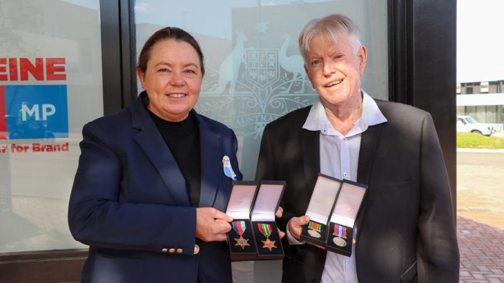 Madeleine King MP hands over Sergeant John Brislin’s WW2 medals to his son, Bruce Brislin, outside her office in Rockingham, WA. Story by Lieutenant Commander John . Photos Supplied.