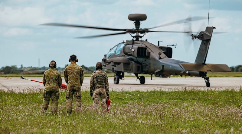 A British soldier from 3 Regiment Army Air Corps and soldiers from the 1st Aviation Regiment, Australian Army Aviation Command, observed as a AH-64E attack helicopter taxis down the pan during their learning experience at Wattisham Flying Station. Story by Major Lily Charles. Photos by Photos: Corporal Aaron J Stone.