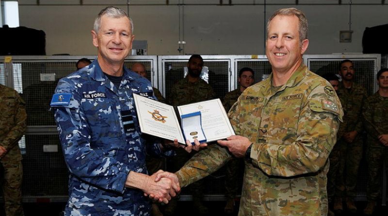 Air Commander Australia Air Vice-Marshal Glen Braz, left, awards Leading Aircraftman Samuel Conroy with a gold commendation at 1 Security Forces Squadron, RAAF Base Williamtown. Story by Flight Lieutenant Grace Casey-Maughan.