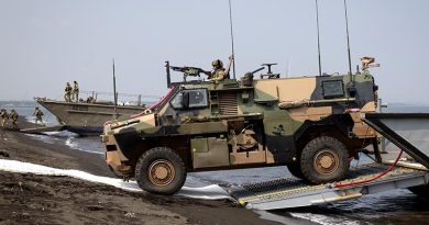 An Australian Army Bushmaster protected mobility vehicle disembarks from a landing craft during Exercise Keris Woomera at Banongan Beach, Indonesia. Photo by Leading Seaman Rikki-Lea Phillips.
