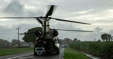 A member of the public from Halifax, QLD unloads critical supplies from a CH-47F Chinook helicopter from 5th Aviation Regiment during their assistance to North Queensland floods in February 2025. Story by Lieutenant Tahlia Merigan. Photo by Captain Chloe Elmwood.