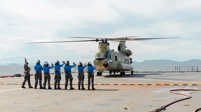 Members of HMAS Choules’ flight deck team prepare an Army CH-47 Chinook for take-off during deck-landing practice while off the coast of Townsville. Story by Chief Petty Officer Helen Frank. Photos by Able Seaman Danyellah Hill.