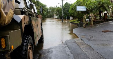 Sergeant Paul Dennis, left, and Lieutenant Jack Macklan talk to Lismore resident Chris McNamara near the flooded Wilsons River during a joint patrol to monitor floodwaters as part of Operation Topical Cyclone Alfred Assist. Story by Lieutenant Emily Tinker. Photos: byWarrant Officer Class 2 Raymond Vance.