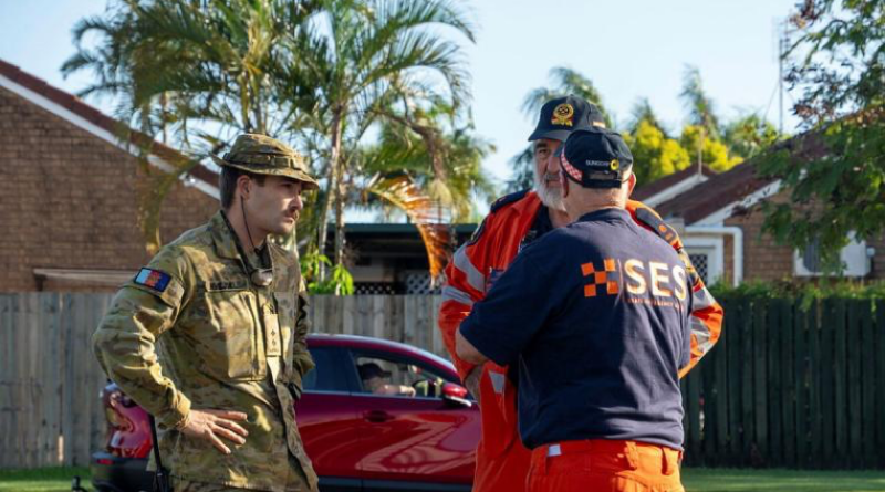 Australian Army officer Lieutenant Andrew Hvejsel, from 6 Battalion, Royal Australian Regiment, talks with Queensland State Emergency Service officers about assisting Hervey Bay residents in the wake of Ex-Tropical Cyclone Alfred. Story by Captain Cody Tsaousis. Photo by Private Gabriel Argent.