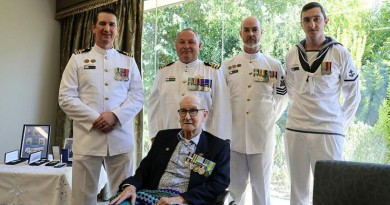 Commanding Officer HMAS Encounter Commander Tony Ryder presents veteran Able Seaman Colin Cherry with his medals for naval service during the Korean War, surrounded by Lieutenant Commander Gavin Colgan, Petty Officer Warren Sanders and Leading Seaman Dylan Sanders.