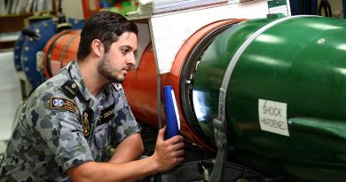 Able Seaman Matthew Dockrill conducts a routine inspection between the after body and fuel cell of a MK48 Heavy Weight Torpedo in the Torpedo Maintenance Facility at the Navy Guided Weapons Systems Program Office-West on HMAS Stirling. Photo by Chief Petty Officer Damian Pawlenko.