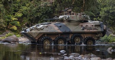An Australian light-armoured vehicle (ASLAV) negotiates a creek crossing during an exercise at Jungle Training Wing, Tully, Queensland. Photo by Corporal Nicole Dorrett.
