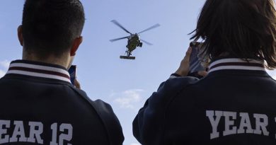 Geelong High School students watch as a Royal Australian Navy MH-60R Seahawk helicopter prepares to land on the school oval during a visit by Royal Australian Navy personnel. Photo by Warrant Officer Ricky Fuller.