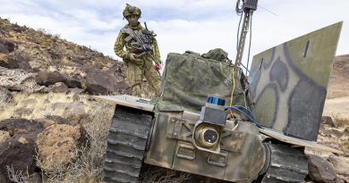 An Australian Army soldier from the 1st Armoured Regiment with an uncrewed ground vehicle equipped with a prototype communications system and experimental drone launcher during Project Convergence Capstone 5 at Fort Irwin, California. Photo by Corporal Nakia Chapman.