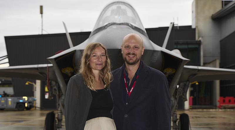 Sam Boyd and his partner pose in front of an F-35 fighter after Mr Boyd's appointment as a RAAF officer, at No. 2 Operational Conversion Unit, RAAF Base Williamtown. Photo by Leading Aircraftwoman Laura Flower.
