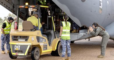 Royal Australian Air Force aviators assist local man Brian Dayes unload fuel stores from a C-27J Spartan in Windorah, Queensland. Photo by Aircraftwoman Nell Bradbury.