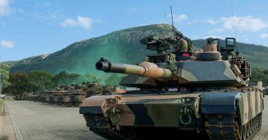 Personnel use an Australian Army M1A2 Abrams from 2nd Cavalry Regiment to provide security during the D Squadron raising ceremony at Lavarack Barracks, Townsville. Story by Captain Brittany Evans. Photo by Corporal Riley Blennerhassett.