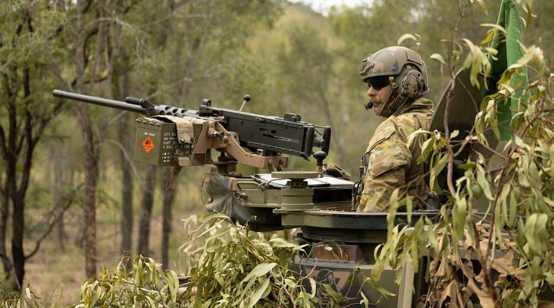 A soldier from the 2nd Cavalry Regiment stands in his Australian Light Armoured Vehicle before a live-fire serial in the Townsville Field Training Area during Exercise Eagle March. Story and photos by Sergeant Matthew Bickerton.