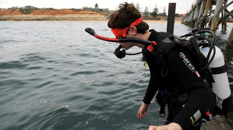Patrick Killen enters the water from Port Noarlunga Jetty as part of the Veterans Dive Initiative open water course. Story and photos by Captain Peter March.