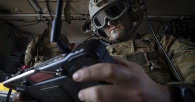 An Australian Army trooper from the 1st Armoured Regiment remotely controls a weapon system on an optionally crewed armoured vehicle during a demonstration in Puckapunyal, Victoria. Photo by Sergeant Tristan Kennedy.