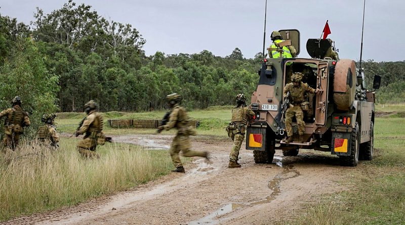 Aviators from 2 Security Forces Squadron disembark from a Bushmaster during a live-fire section attack activity as part of Exercise Crack Thump 3 at Singleton Military Area. Photos by Corporal Michael Rogers.