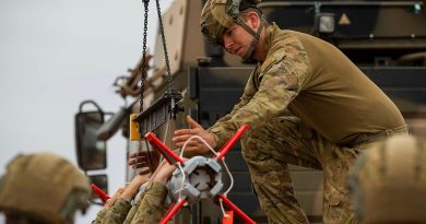 Australian Army soldier Gunner Thomas Hayes, from 111 Battery, 16th Regiment, Royal Australian Artillery, helps load a Sidewinder missile on a NASAMS High-Mobility Launcher during a live-fire certification activity at Woomera Test Range, South Australia. Story and photos by Corporal Jacob Joseph.