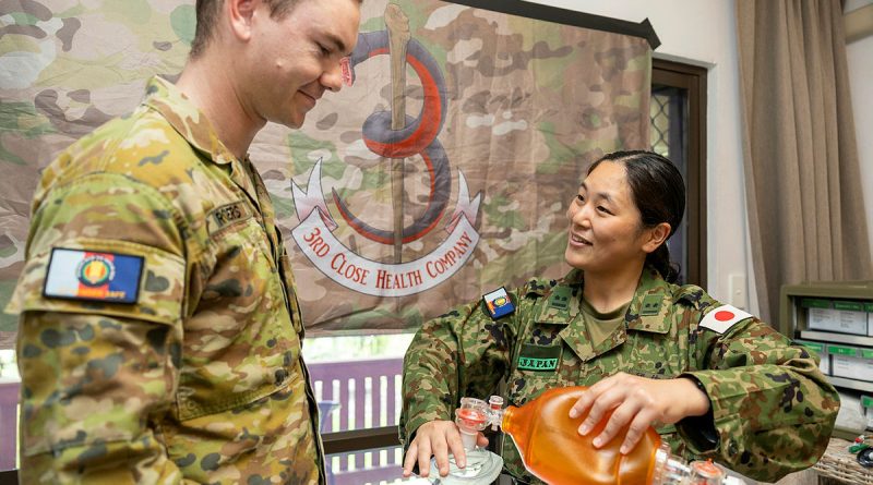 Australian Army Private Kamarga Rogers, from 3rd Close Health Battalion, discusses medical techniques with Lieutenant Susami Shiori of the Japan Self-Defense Force during Operation Render Safe. Story by Captain Katy Manning. Photos by Petty Officer Bradley Darvill.
