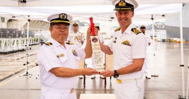 Japanese Maritime Self Defense Force Captain Ishidera Takahiko receives a personalised cricket bat from Commanding Officer HMAS Sydney, Commander Ben Weller, on arrival in Yokosuka during a regional presence deployment. Story by Lieutenant Hinako Shiraishi. Photos by Leading Seaman David Cox.