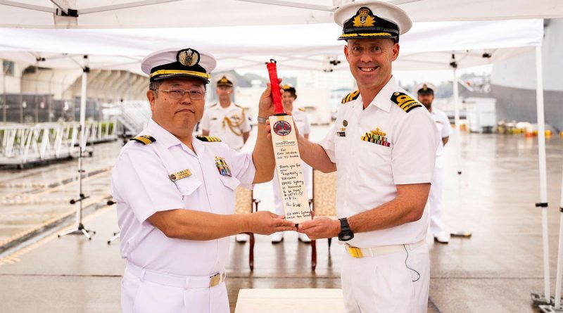 Japanese Maritime Self Defense Force Captain Ishidera Takahiko receives a personalised cricket bat from Commanding Officer HMAS Sydney, Commander Ben Weller, on arrival in Yokosuka during a regional presence deployment. Story by Lieutenant Hinako Shiraishi. Photos by Leading Seaman David Cox.