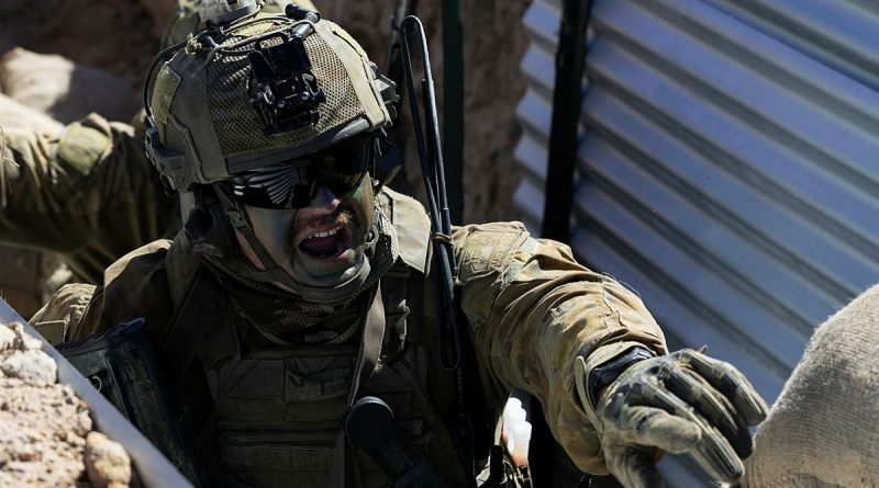 An Australian Army soldier from the 1st Battalion, The Royal Australian Regiment, delivers orders during a blank fire trench serial at Townsville Field Training Area. Story by Corporal Michael Rogers. Photo by Lance Corporal Caitlyn Davill.