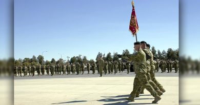 The Standard of the 1st Armoured Regiment is marched onto parade.