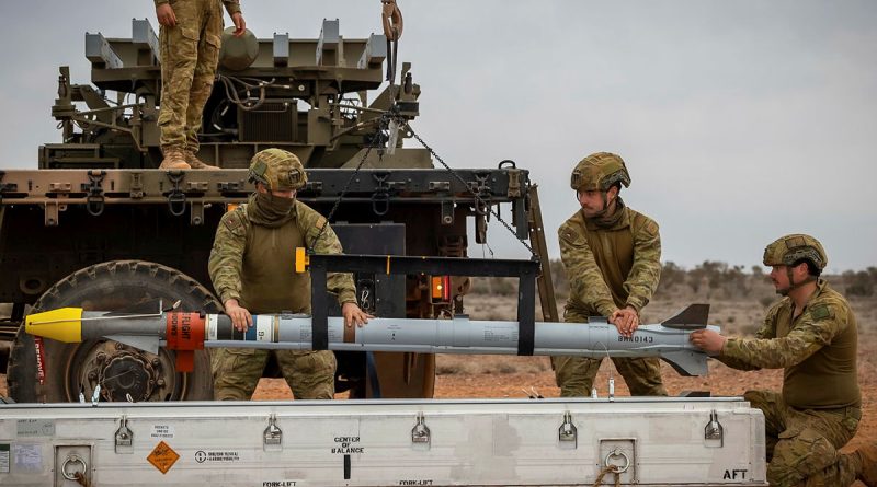 Soldiers from the 16th Regiment, Royal Australian Artillery, load Sidewinder missiles on a NASAMS High-Mobility Launcher at Woomera Test Range, South Australia. Story and photos by Corporal Jacob Joseph.