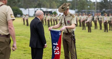 Major Andrew Penhaligon, 133rd Battery Commander, 20th Regiment, Royal Australian Artillery, receives the battery flag from former battery commander, Major Allan Harrison (Retired), during the Regiments Locating Artillery Centenary Parade at Gallipoli Barracks, Enoggera. Story by Major Carolyn Barnett. Photo by Leading Aircraftsman Luke Donegal.