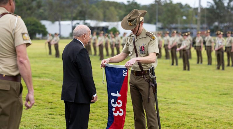 Major Andrew Penhaligon, 133rd Battery Commander, 20th Regiment, Royal Australian Artillery, receives the battery flag from former battery commander, Major Allan Harrison (Retired), during the Regiments Locating Artillery Centenary Parade at Gallipoli Barracks, Enoggera. Story by Major Carolyn Barnett. Photo by Leading Aircraftsman Luke Donegal.