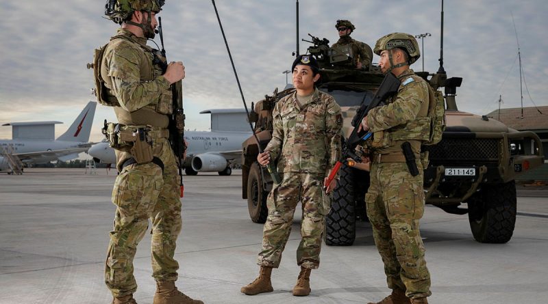 From left, Corporal Dillon Walker, of 2 Security Forces Squadron, talks to Senior Airman Brittany Palomo, of the US Air Force, and Leading Aircraftman John Stratford, of 13 Squadron Security Forces, on the flight line at RAAF Base Darwin. Story by Flight Lieutenant Kayla Walliss. Photos by Sergeant David Gibbs.