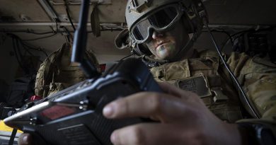 An Australian Army trooper from the 1st Armoured Regiment remotely controls a weapon system on an optionally crewed armoured vehicle during a demonstration in Puckapunyal, Victoria. Photo by Sergeant Tristan Kennedy.