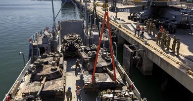 Australian Army soldiers from 2nd Cavalary Regiment, and United States Navy personnel, assist members from Depth Defence Logistics loading M1A2 SEPv3 Abrams main battle tanks to a United States Navy Loading Craft Utility during Exercise Talisman Sabre at the Townsville Port, Queensland. Photo by Lance Corporal Caitlyn Davill.