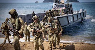 Australian Army soldiers from the 1st Battalion, Royal Australian Regiment, disembark a Royal Australian Navy landing craft at Cowley Beach during Exercise Talisman Sabre 2025. Photo by Corporal Luke Bellman.