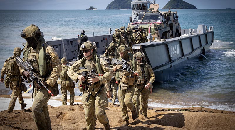 Australian Army soldiers from the 1st Battalion, Royal Australian Regiment, disembark a Royal Australian Navy landing craft at Cowley Beach during Exercise Talisman Sabre 2025. Photo by Corporal Luke Bellman.